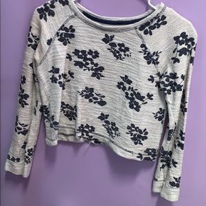 White, soft crop top blouse with blue flowers.